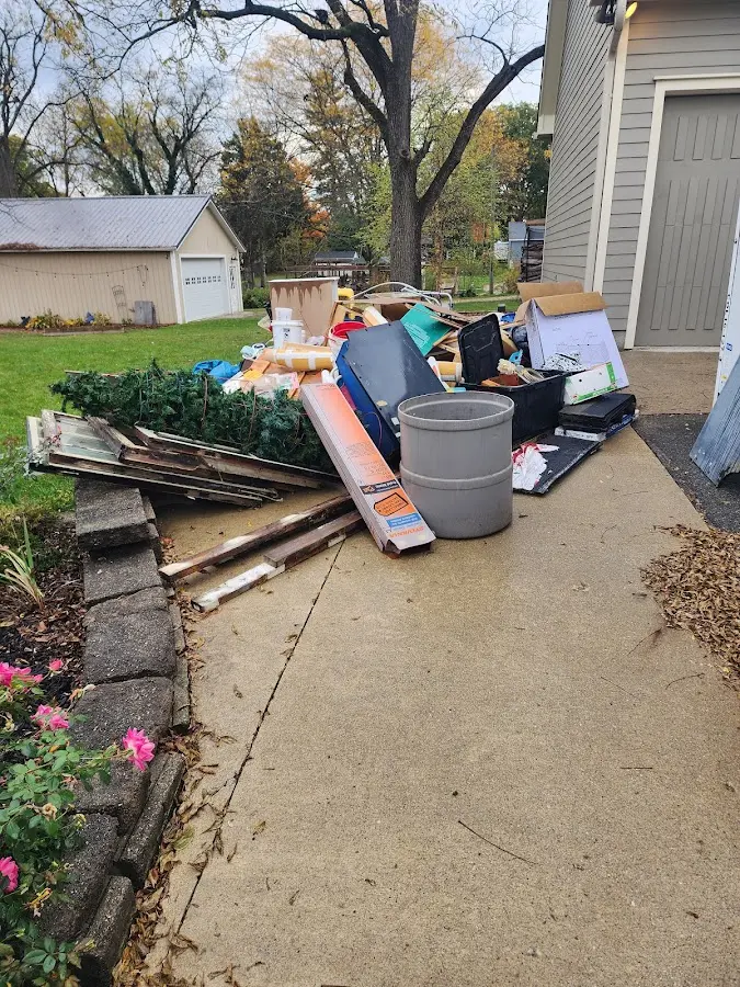 Dumpster being loaded with debris for Estate Cleanout Dumpster Rental in Austin